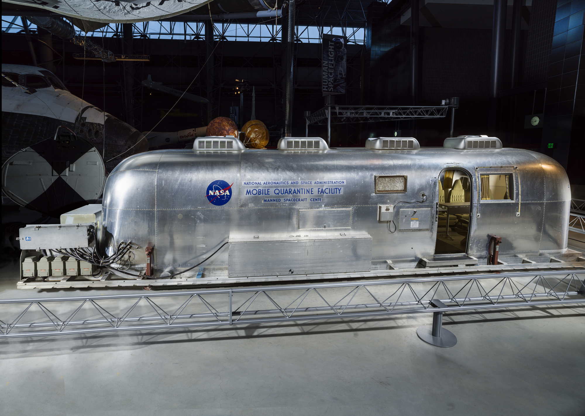 converted airstream trailer with words Mobile Quarantine Facility on it