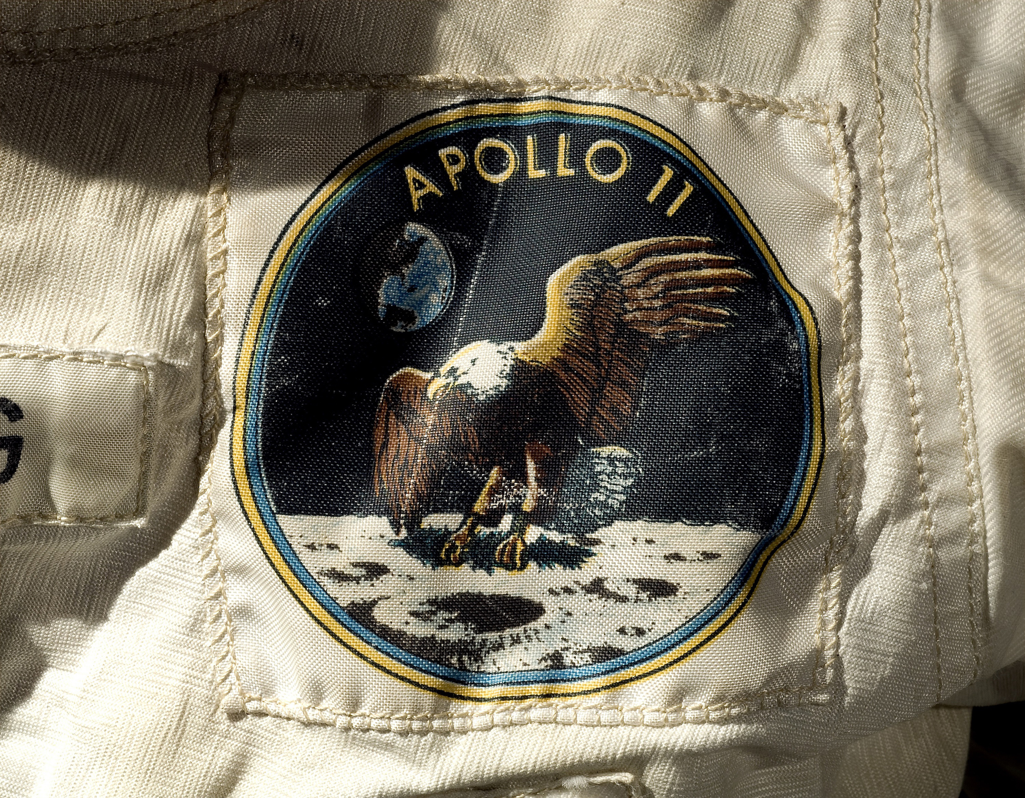 mission patch with eagle on it on a spacesuit