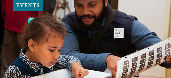 A girl and her father participate in a family program