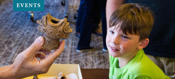 Archaeology Family Day - Boy Looking at Artifact